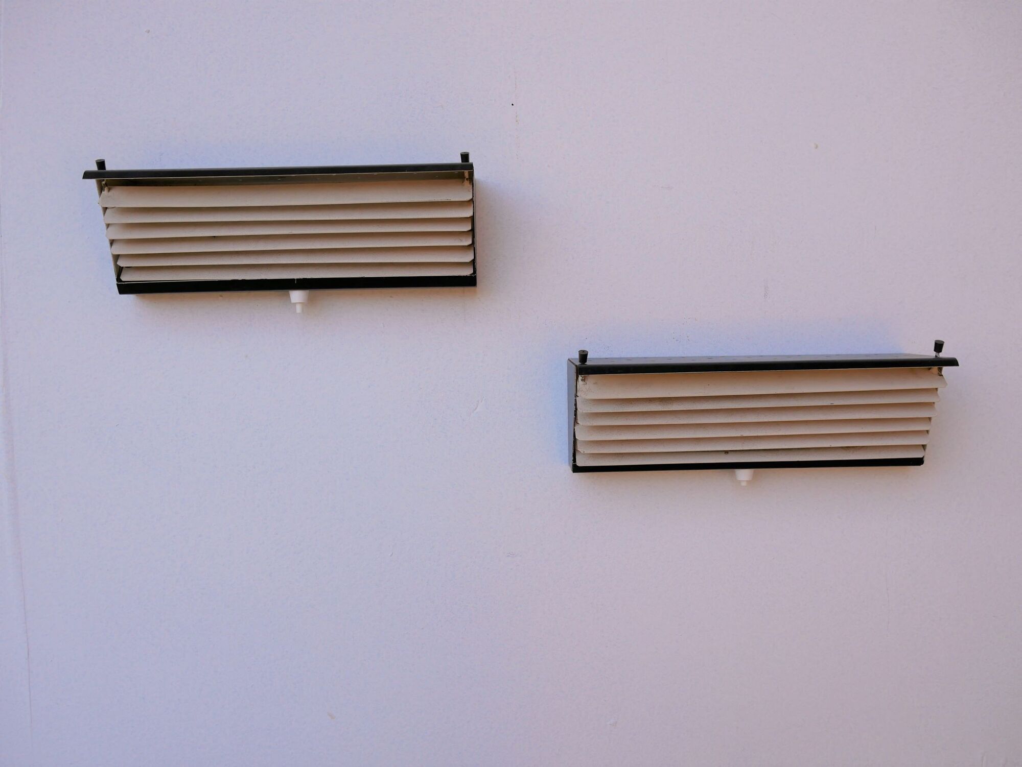 Pair of modernist metal wall light model 212, by Jacques Biny for Luminalite