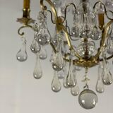 Gilded bronze chandelier trimmed with drop-shaped stamps