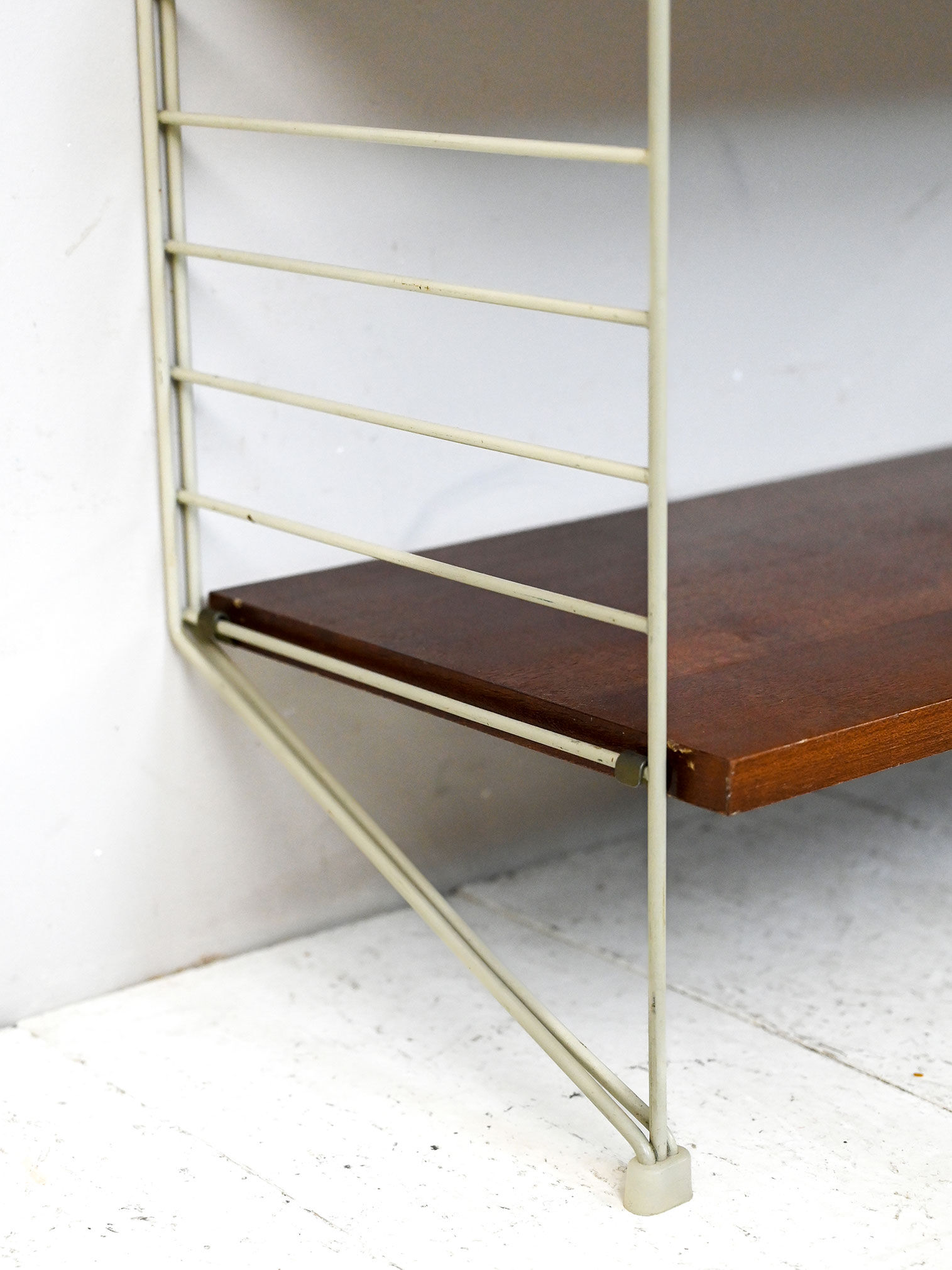 'string' bookcase with metal frame