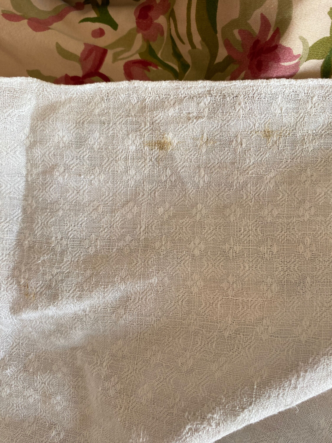 Old white cotton tablecloth.