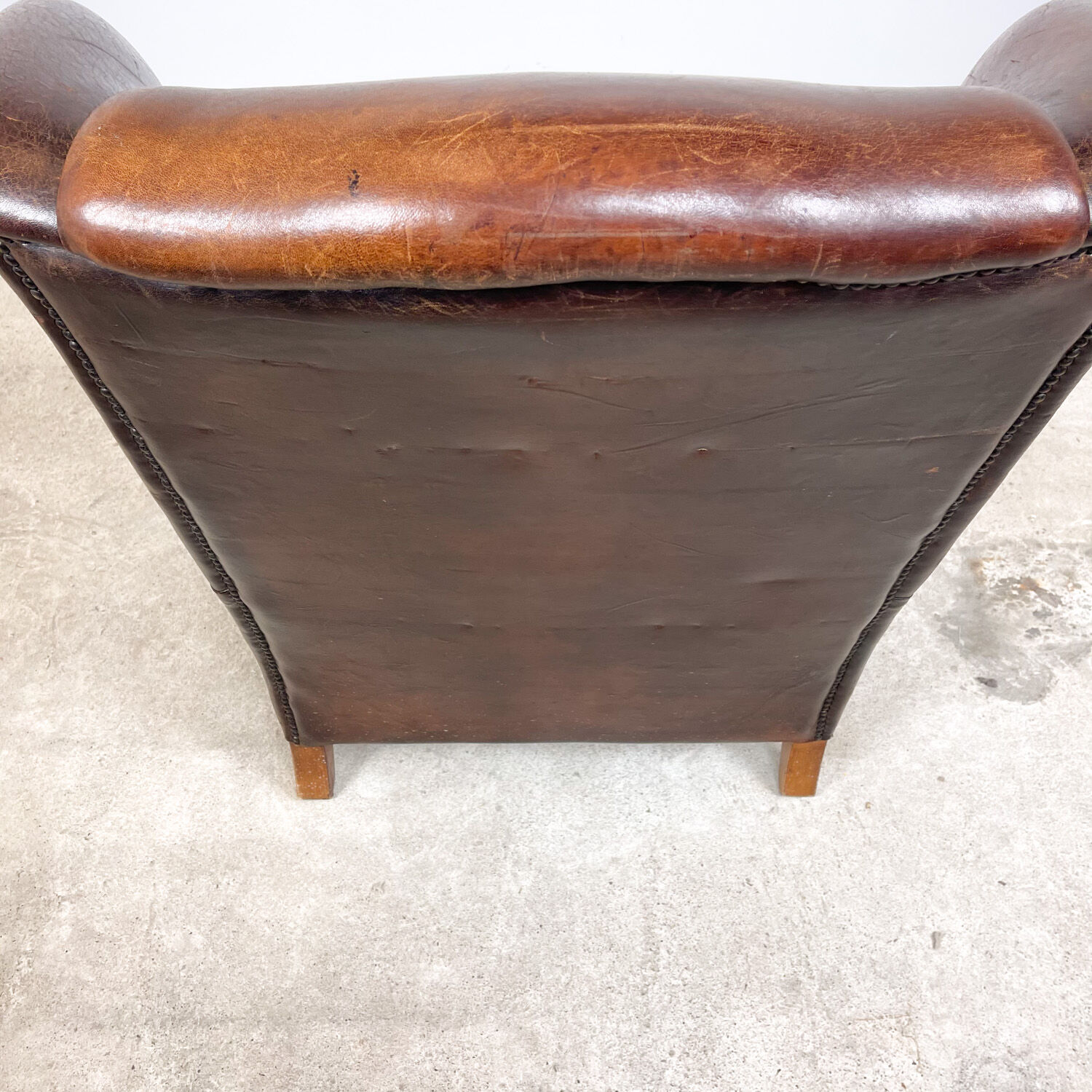 Dark brown vintage sheep leather wingback armchair
