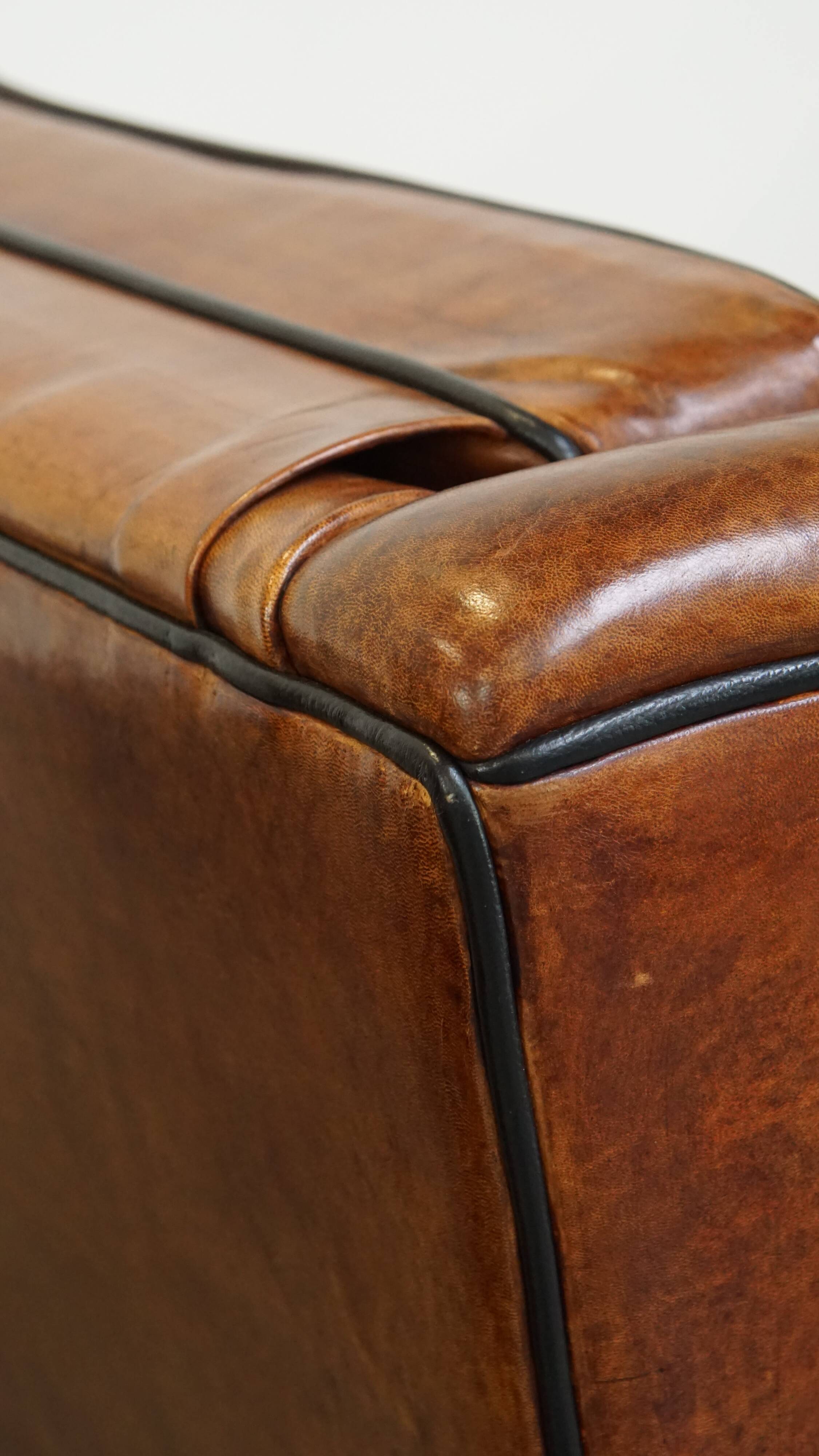 Set of 2 very comfortable large sheepskin armchairs elegantly finished with black piping