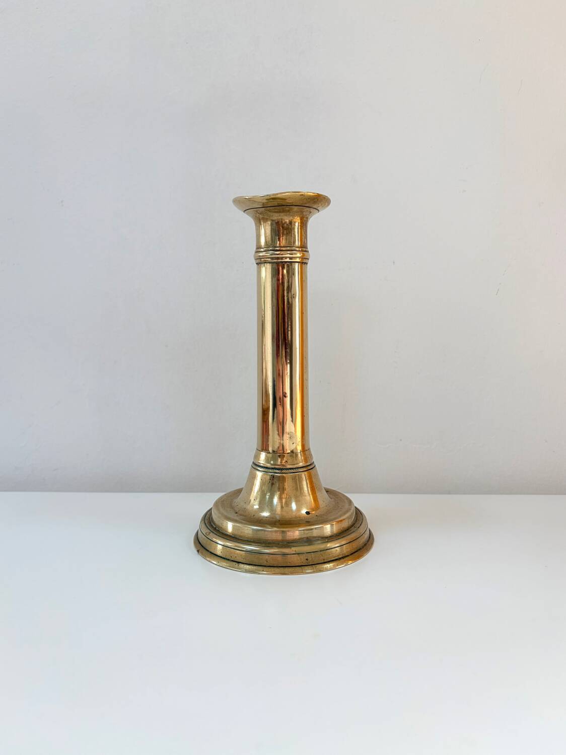Old brass candlestick with push button.
