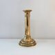 Old brass candlestick with push button.