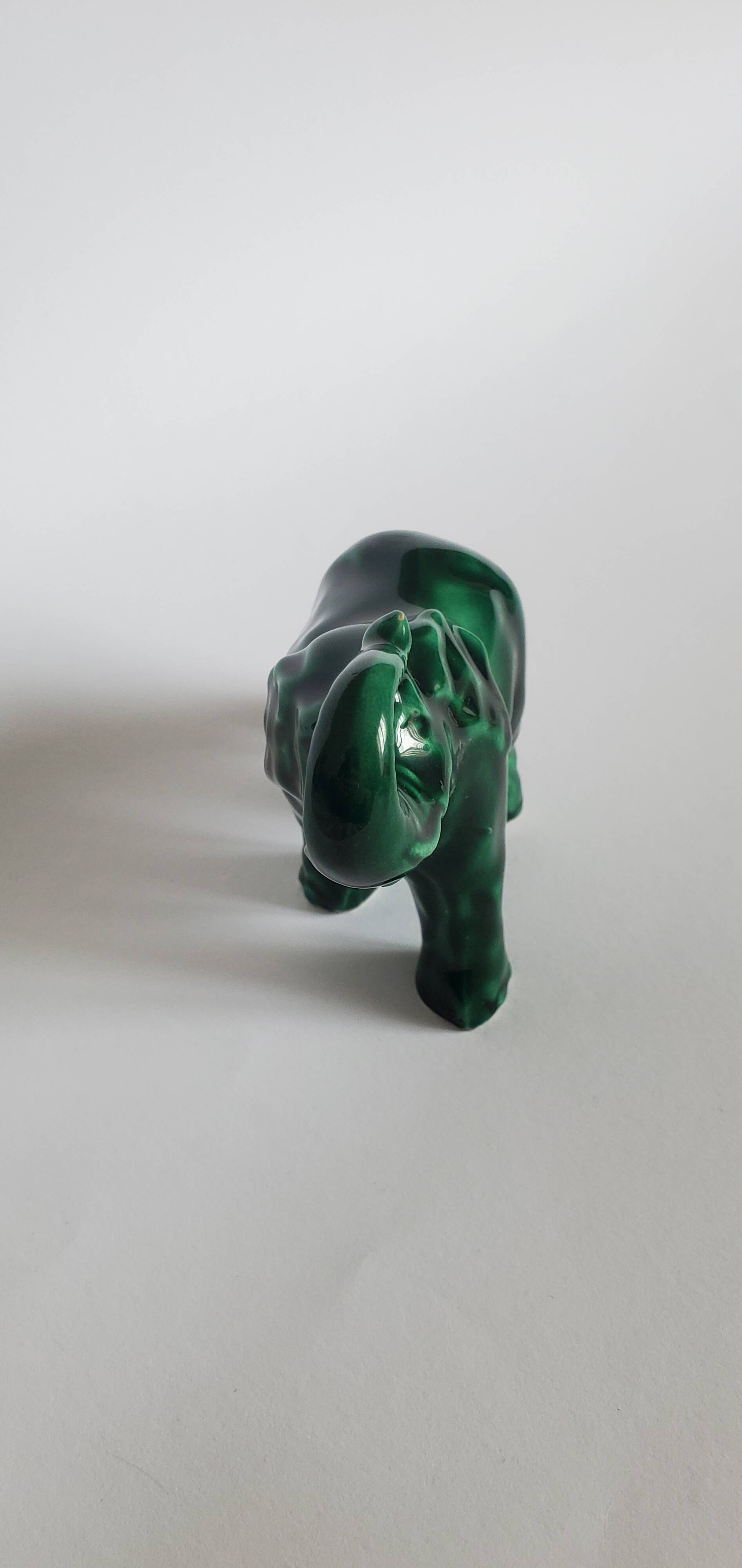 Small emerald green ceramic elephant.