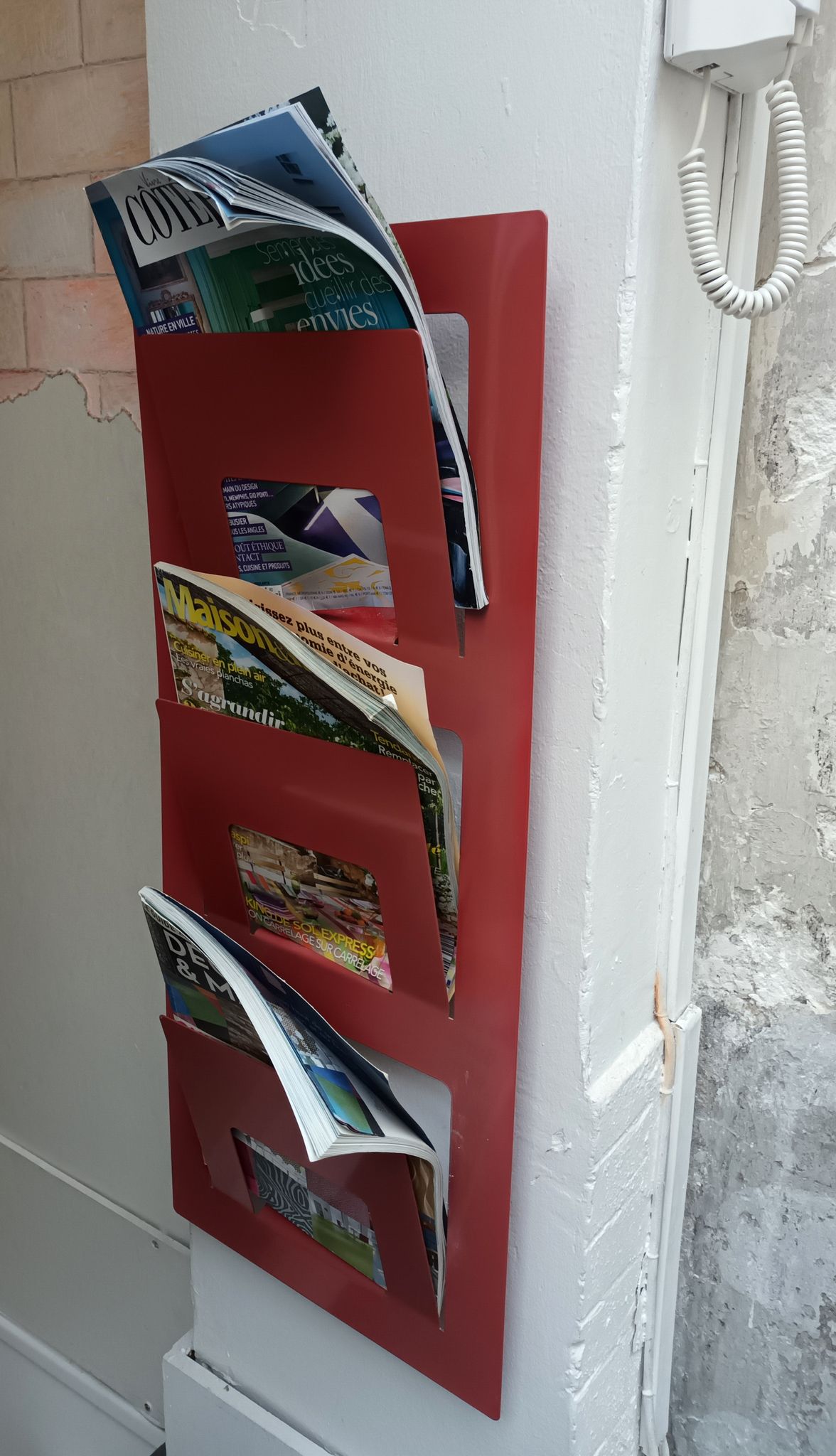 Vintage red metal wall magazine rack