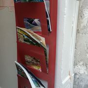Vintage red metal wall magazine rack