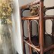 Dark brown 70s bamboo and cane shelf on legs