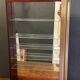 Vitrine en bois doré à suspendre .