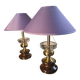 A pair of vintage table lamps featuring a turned wooden base, accessories...