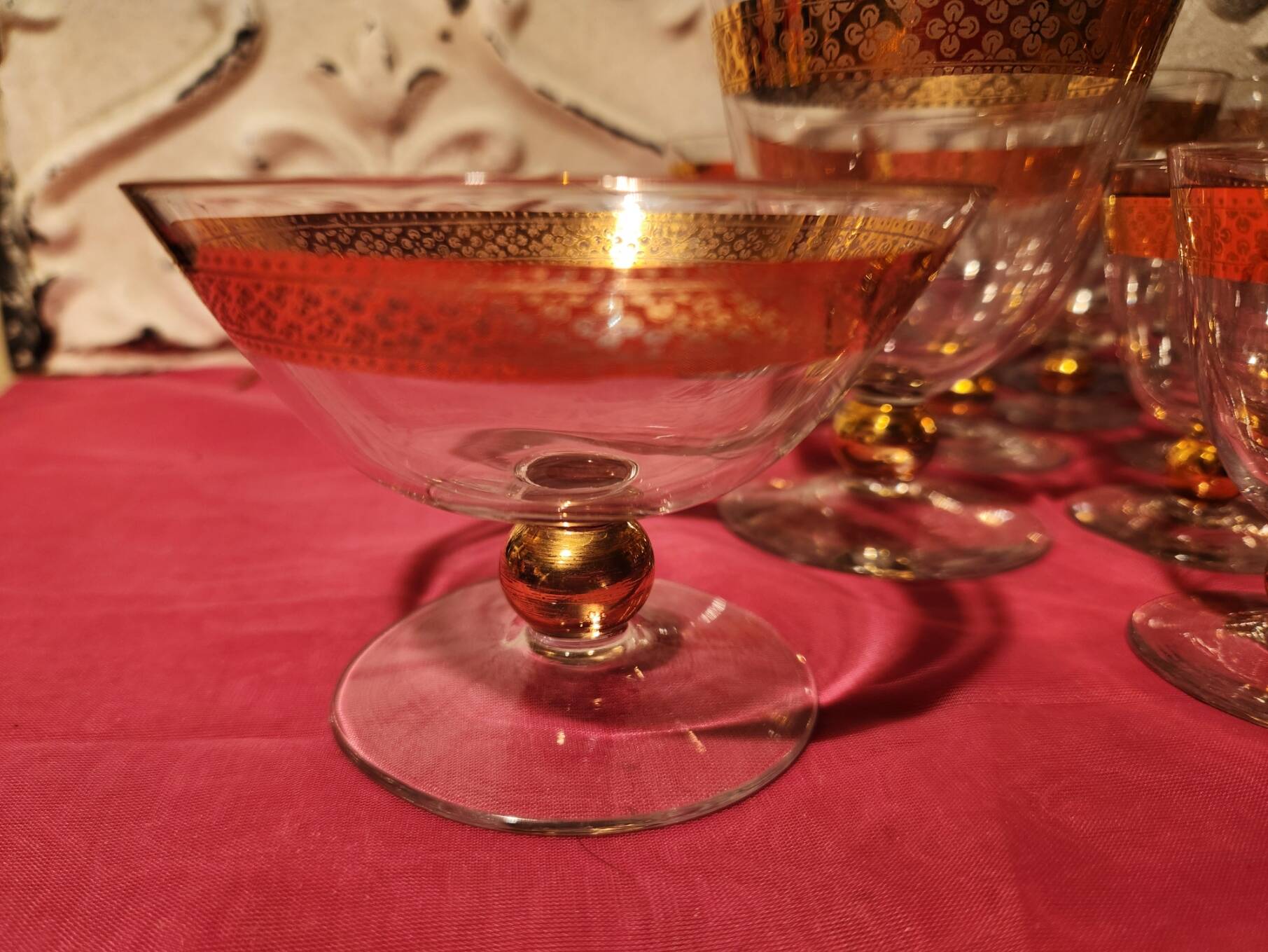 1930s footed glass service with gilding, including champagne flutes.