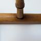 Wall-mounted coat rack made of turned wood
