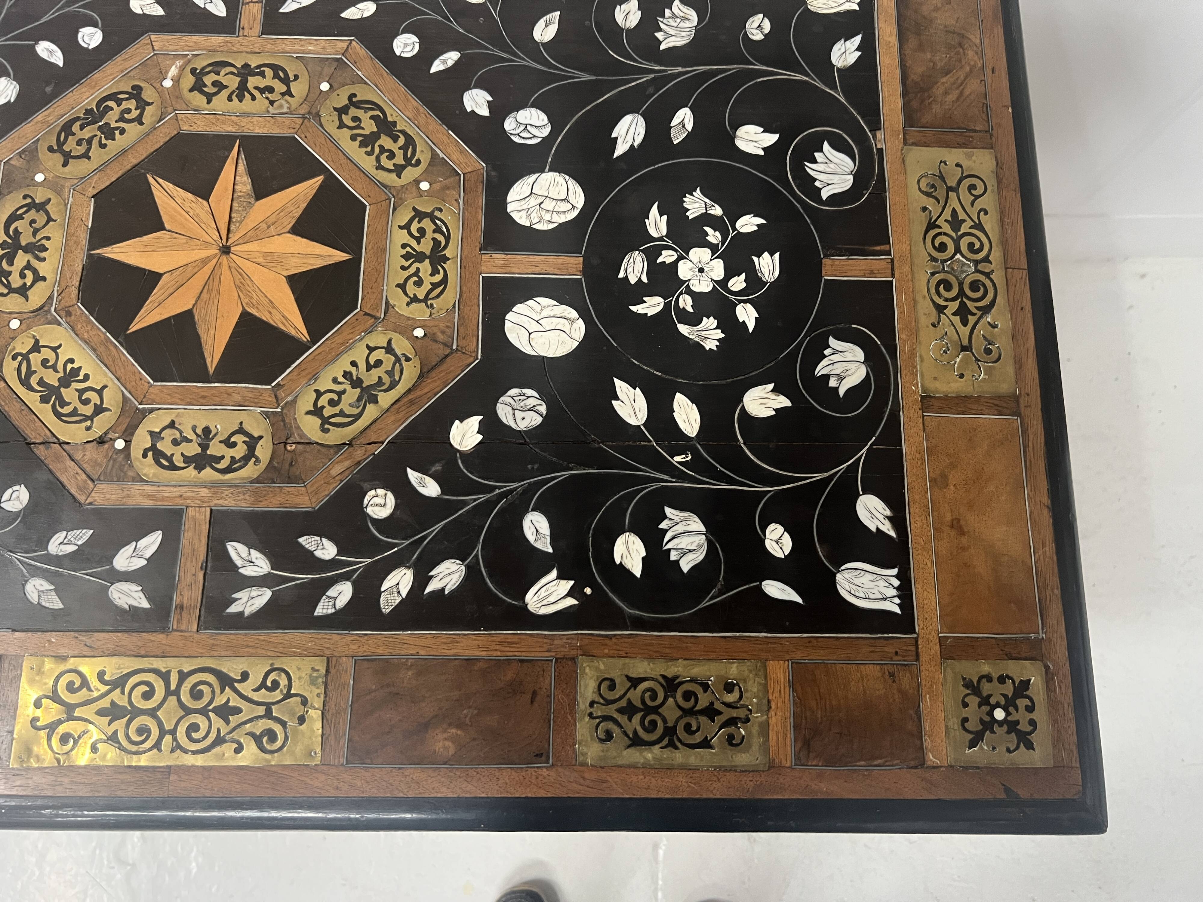 Blackened wood display table with marquetry top, Spain, 19th century.