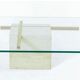 Coffee table with travertine gold-plated cross base and glass top