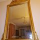 Large beveled mirror with a gilded frame depicting roses