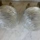 Pair of neoclassical wall sconces in twisted brass and ribbed glass.