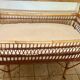 Vintage rattan baby bed with wheels