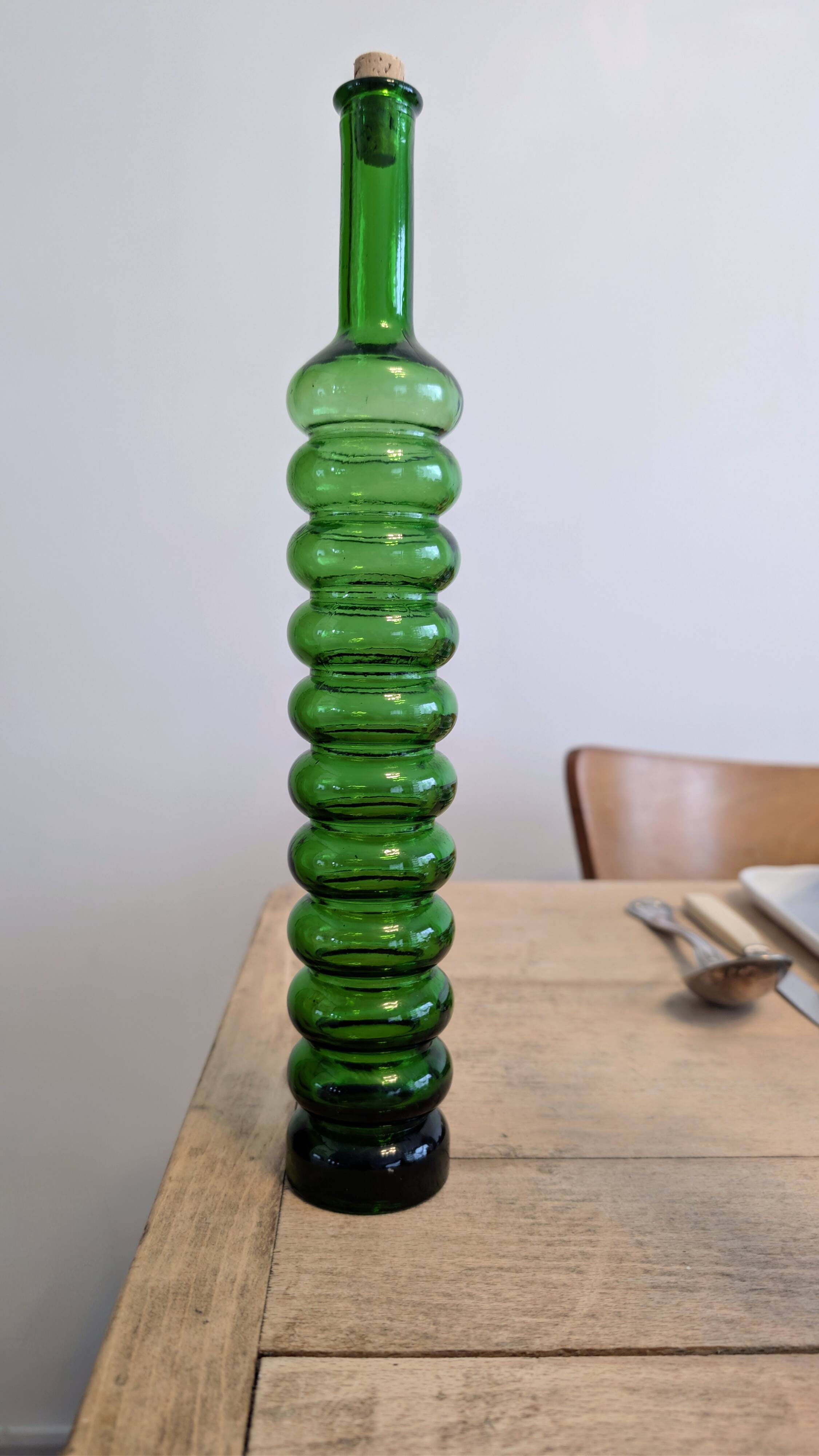 Pair of vintage ribbed blown glass bottles with cork stoppers.