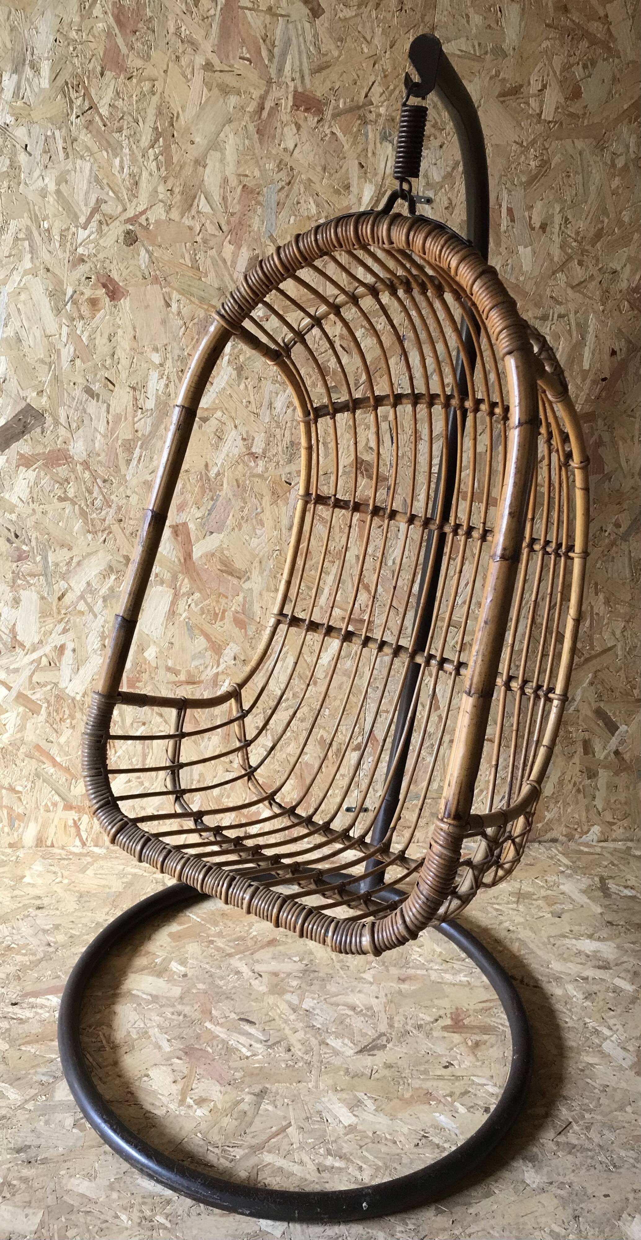 Vintage rattan hanging chair with its stand.