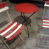 Old tripod table with folding chairs
