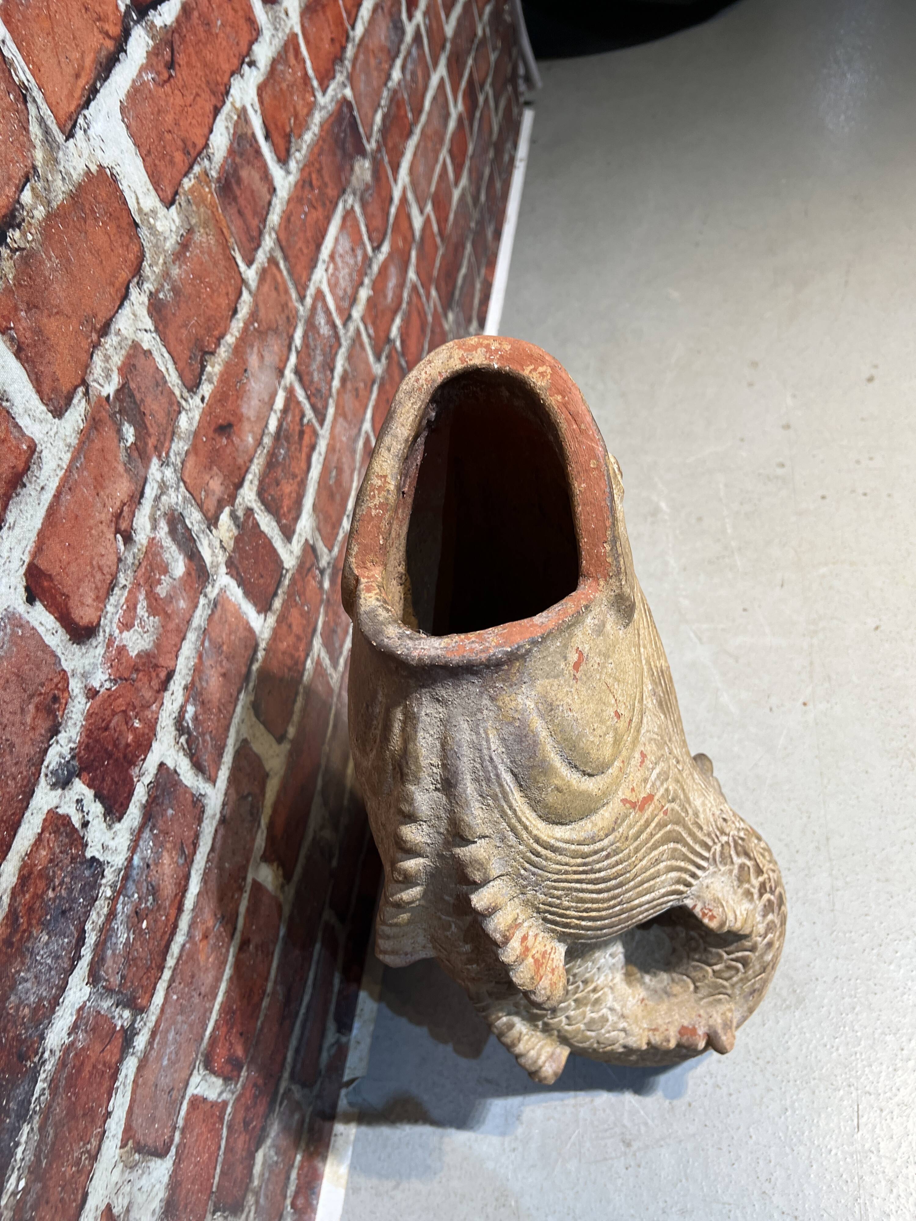 Terracotta umbrella stand in the shape of a fish