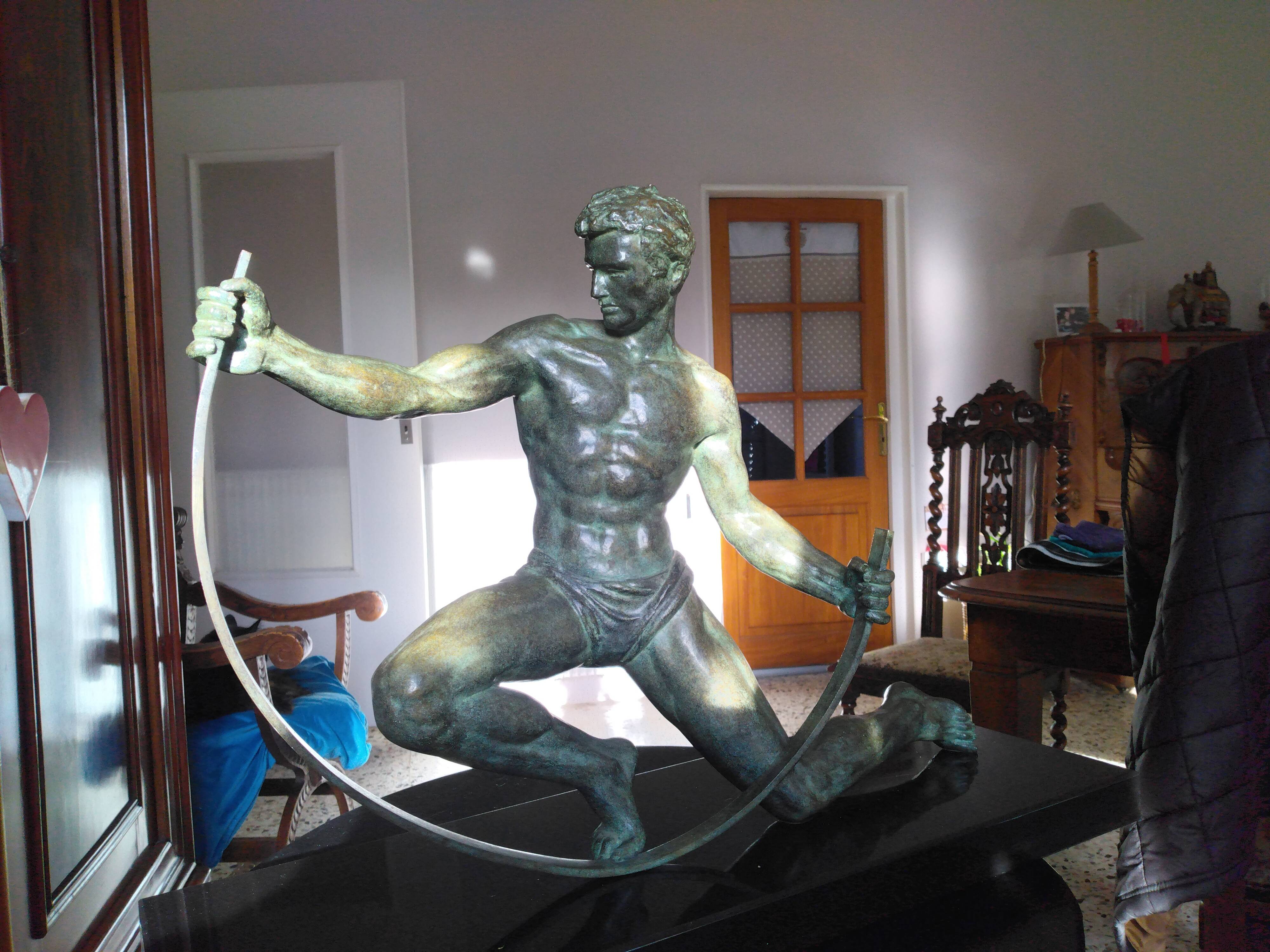bronze sculpture athlete bending an iron bar by Jean de Roncourt on an art deco marble base