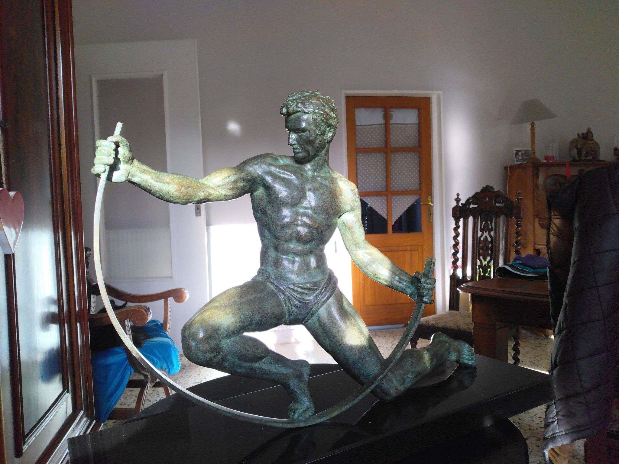 bronze sculpture athlete bending an iron bar by Jean de Roncourt on an art deco marble base