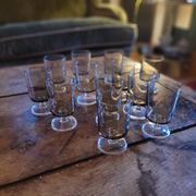 12 smoked glass stemmed glasses from the 70s and 80s.