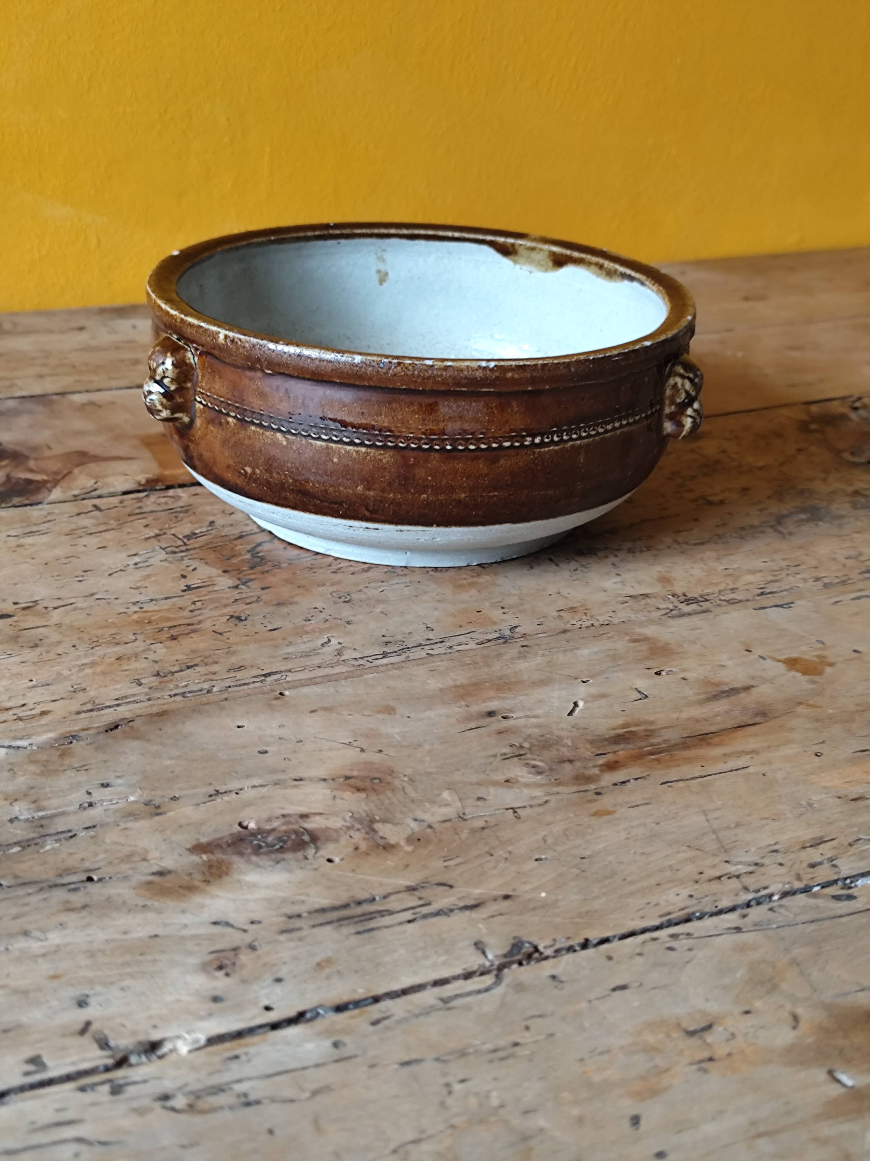 Old small glazed ceramic dish with lion head decoration - brown enamel kitchen bowl