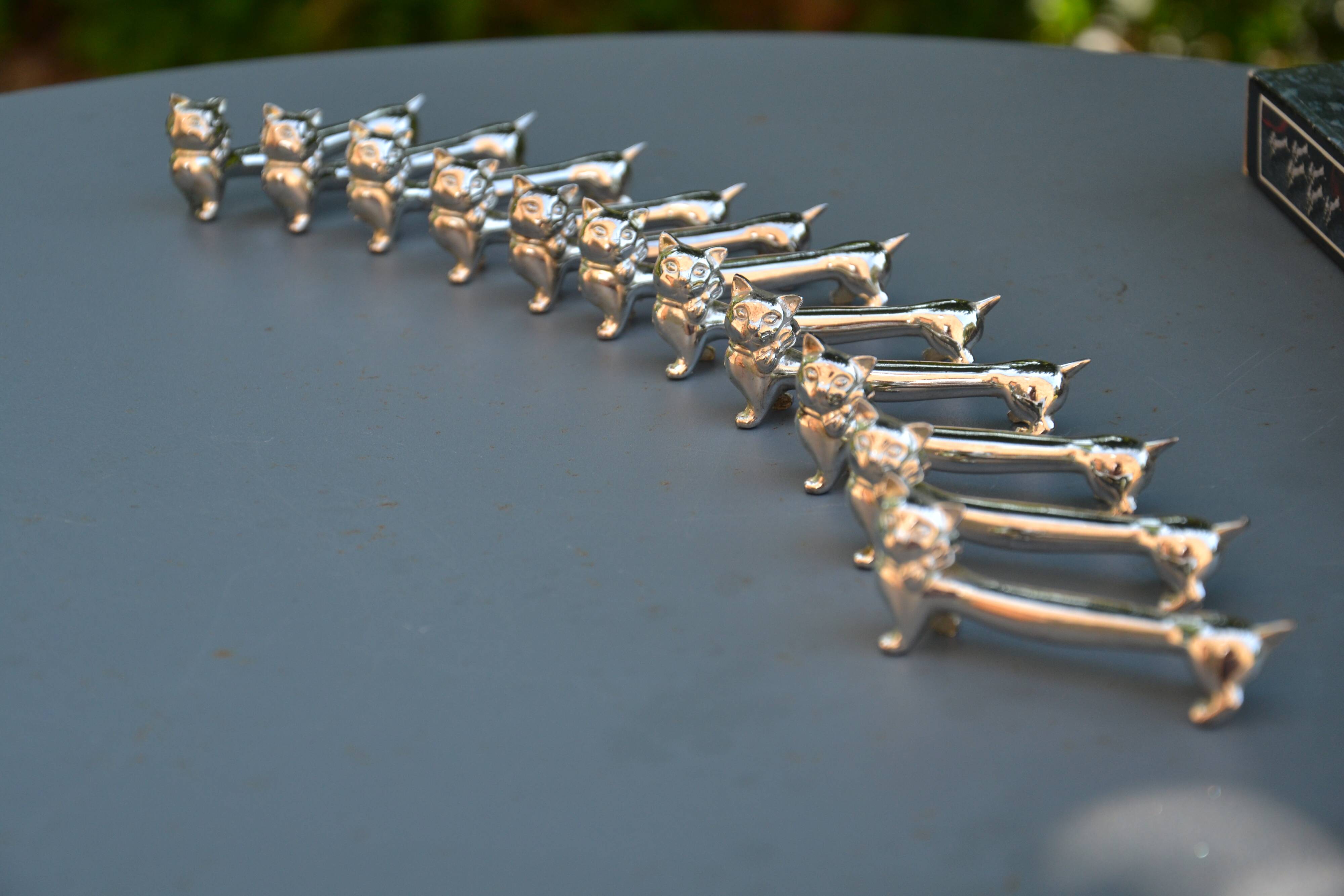 12 silver-plated cat knife rests
