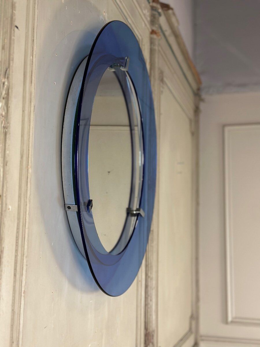 Mirror framed by a blue glass circle, italy circa 1950