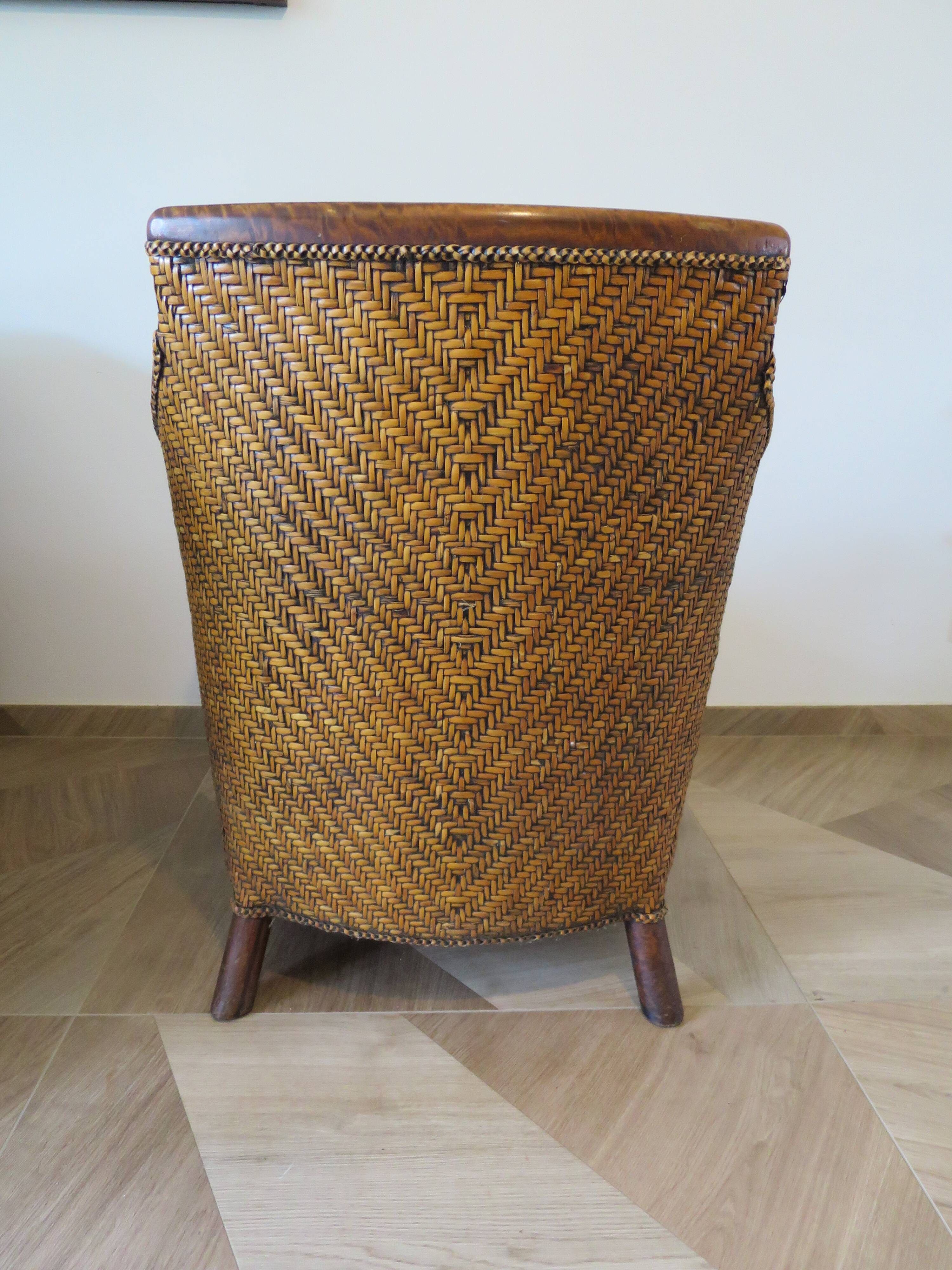 Colonial style armchair in woven rattan and exotic wood