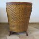 Colonial style armchair in woven rattan and exotic wood