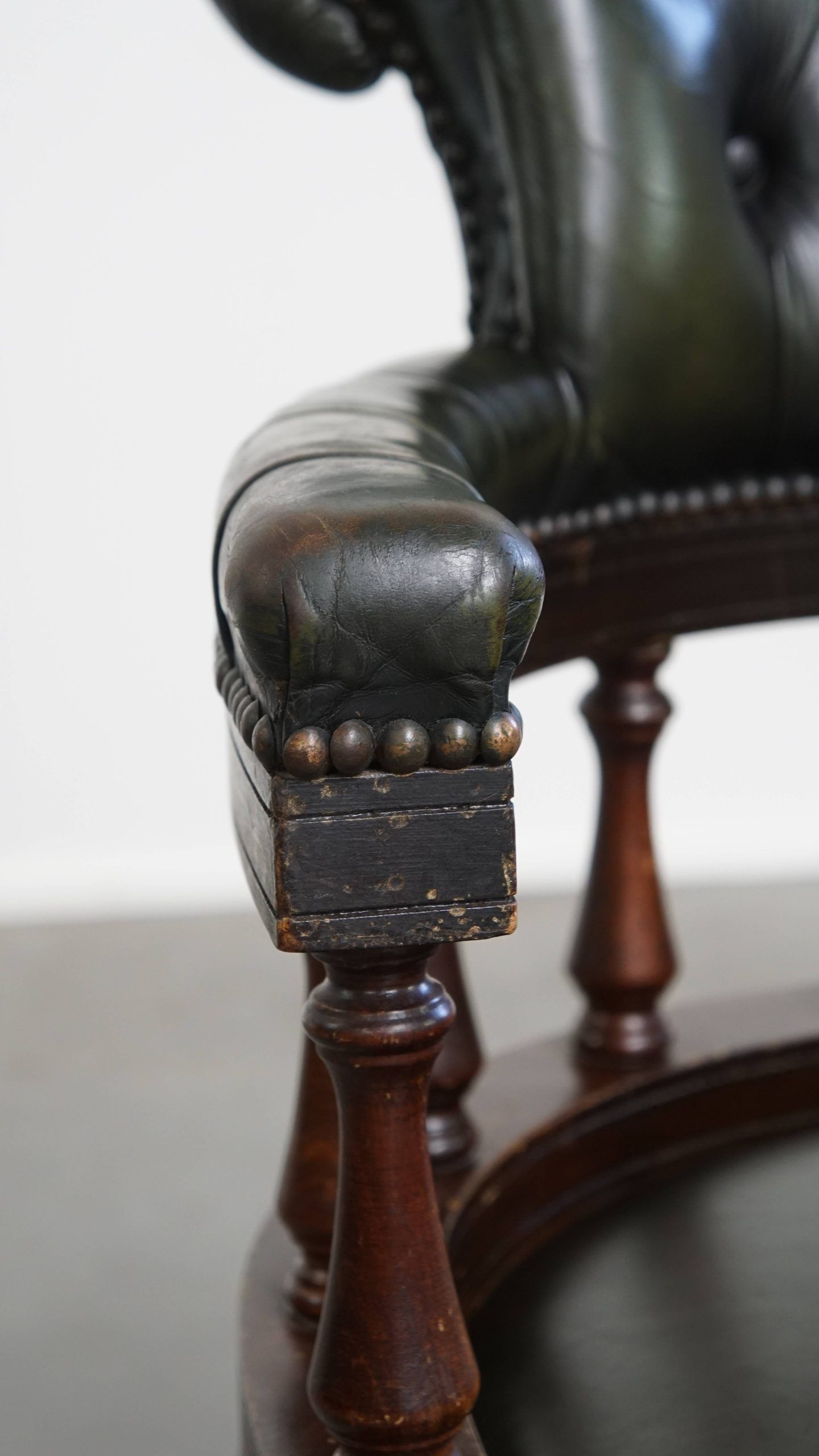 Adjustable green leather and wood Chesterfield office chair with swivel