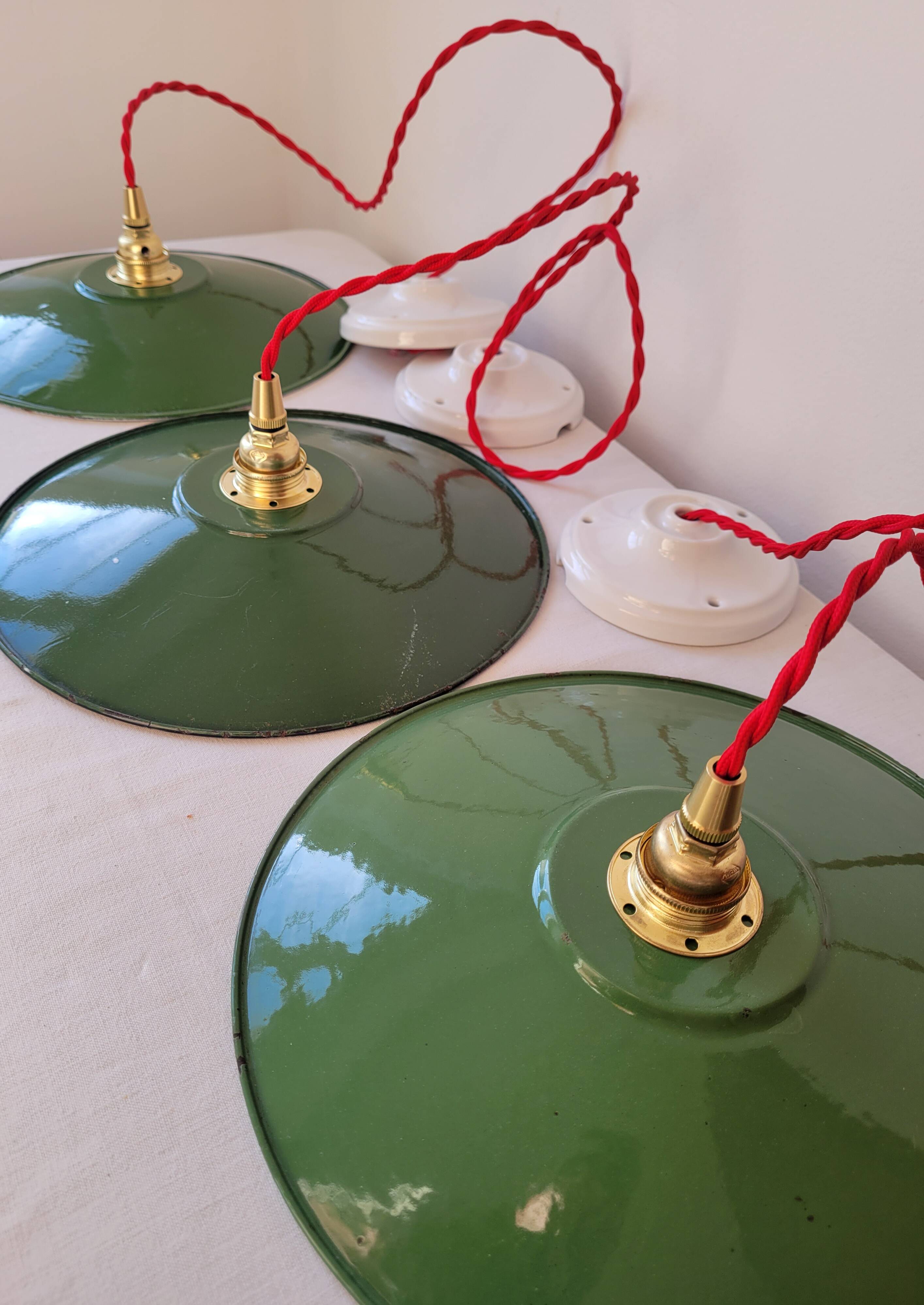 Trio of enameled sheet metal pendant lights