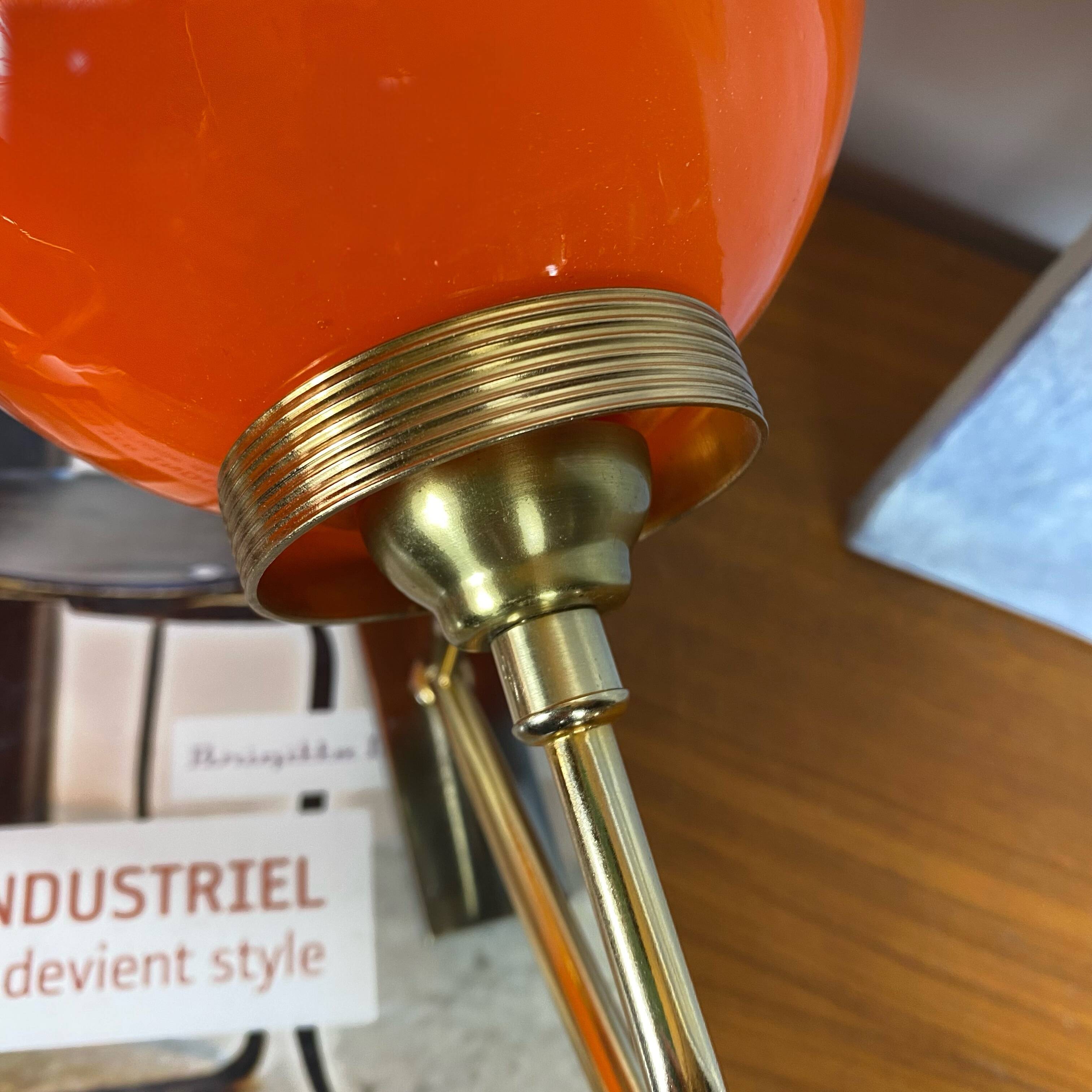 Pair of wall sconces with orange opaline globes and gold metal.