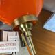 Pair of wall sconces with orange opaline globes and gold metal.
