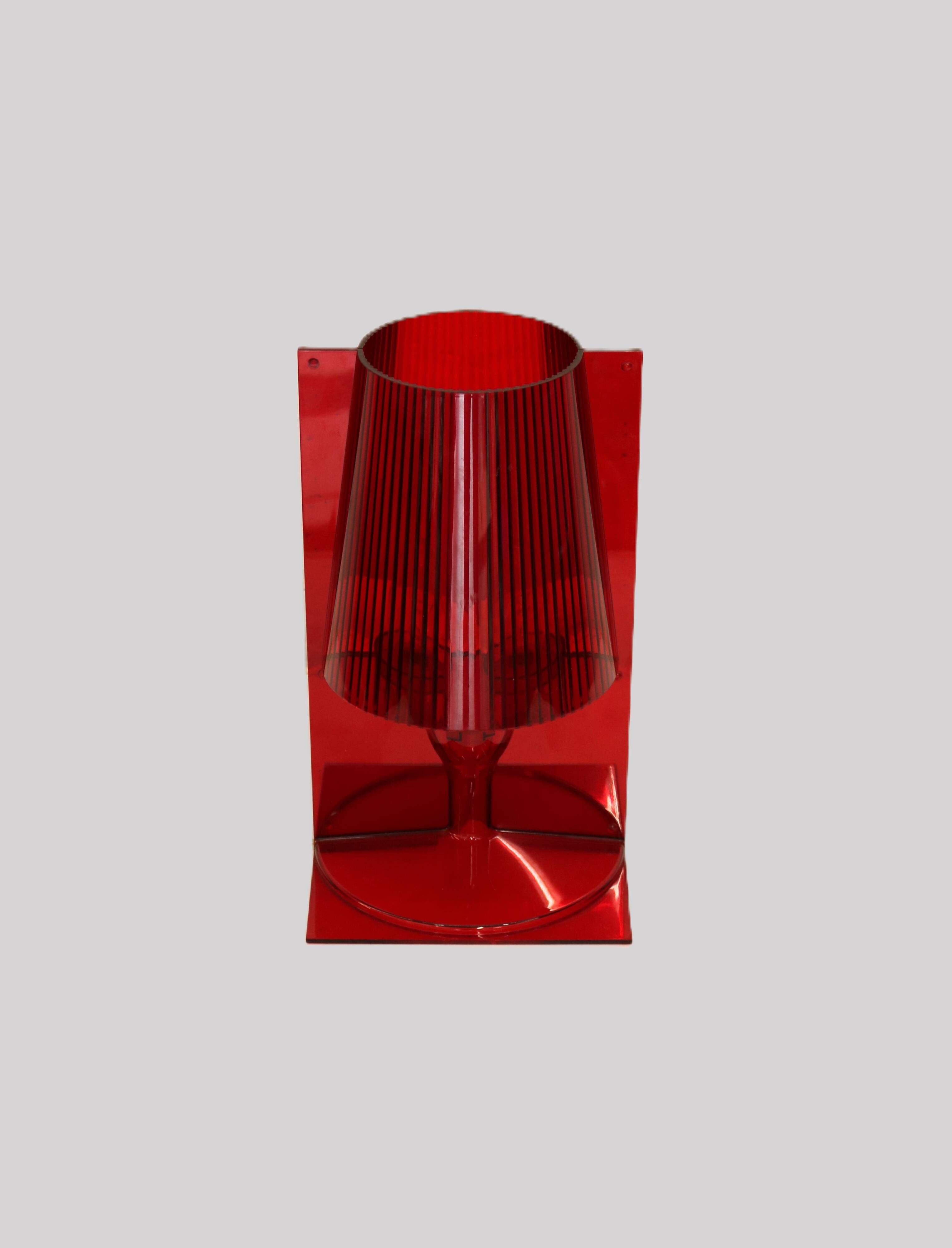 Red plastic Kartell table lamp - model Take - design by Ferruccio Laviani