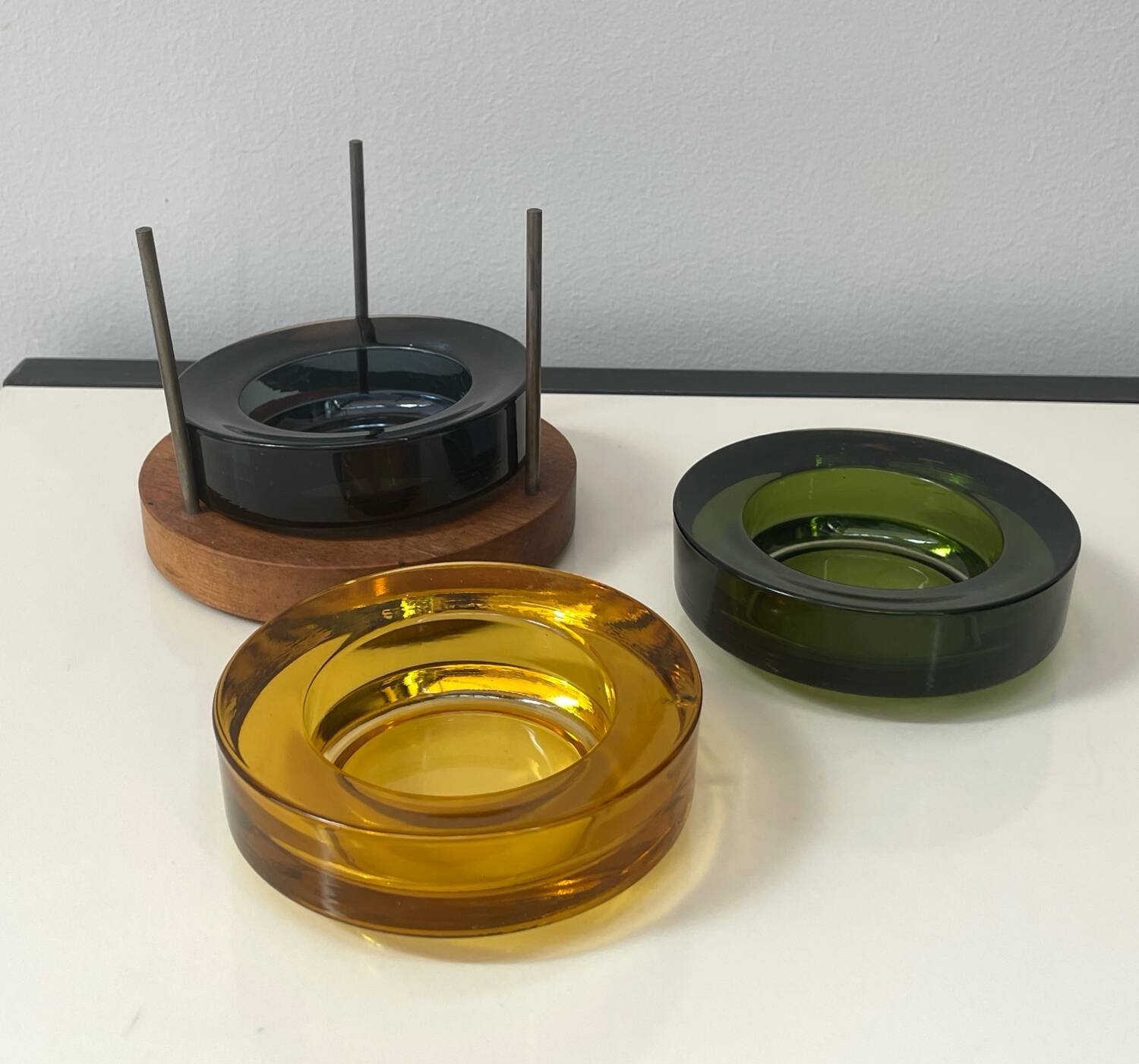 Set of 3 stackable glass catchalls with a teak base.