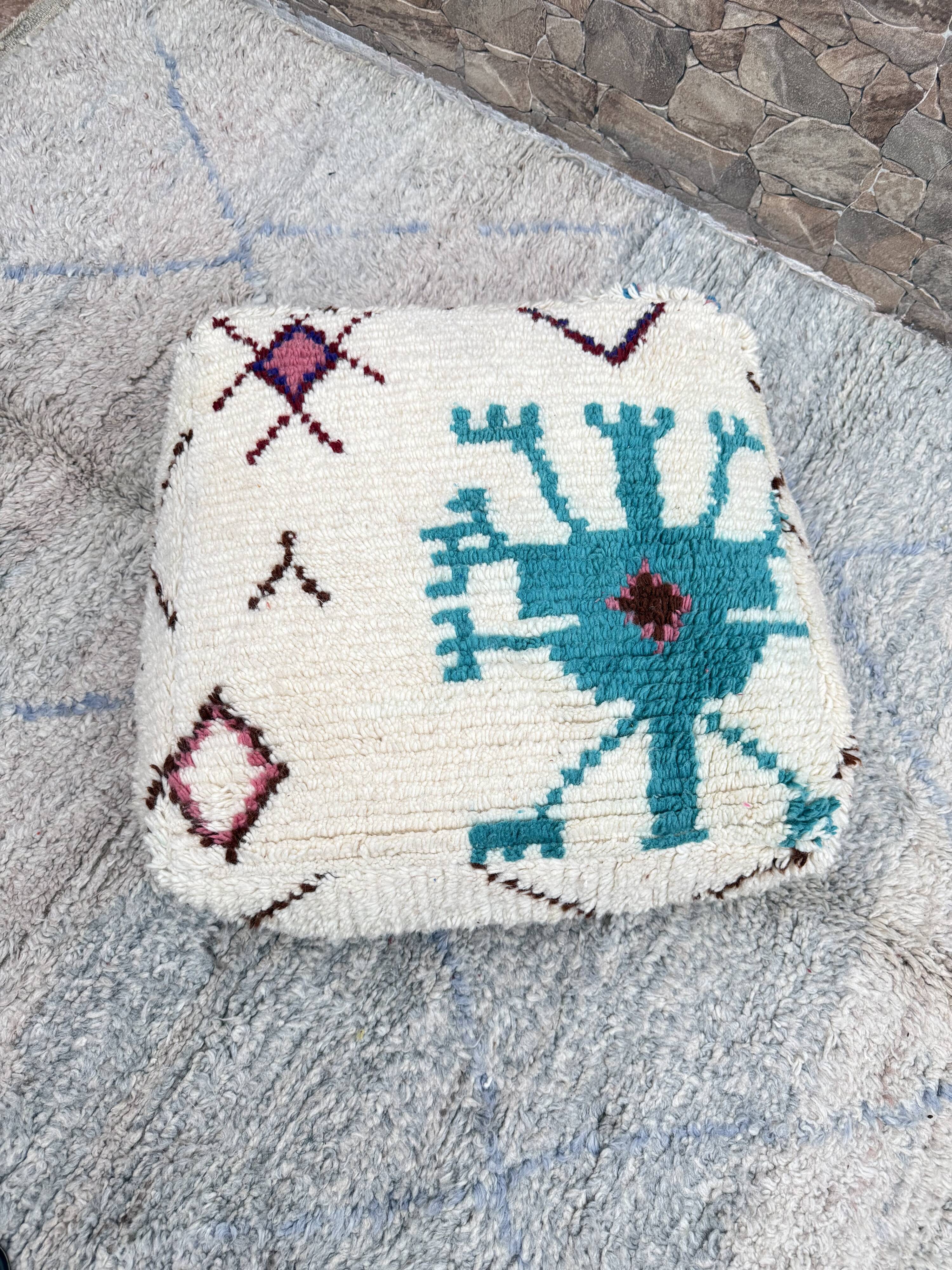 Berber floor pouf: Handwoven Moroccan wool cushion.