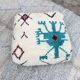 Berber floor pouf: Handwoven Moroccan wool cushion.