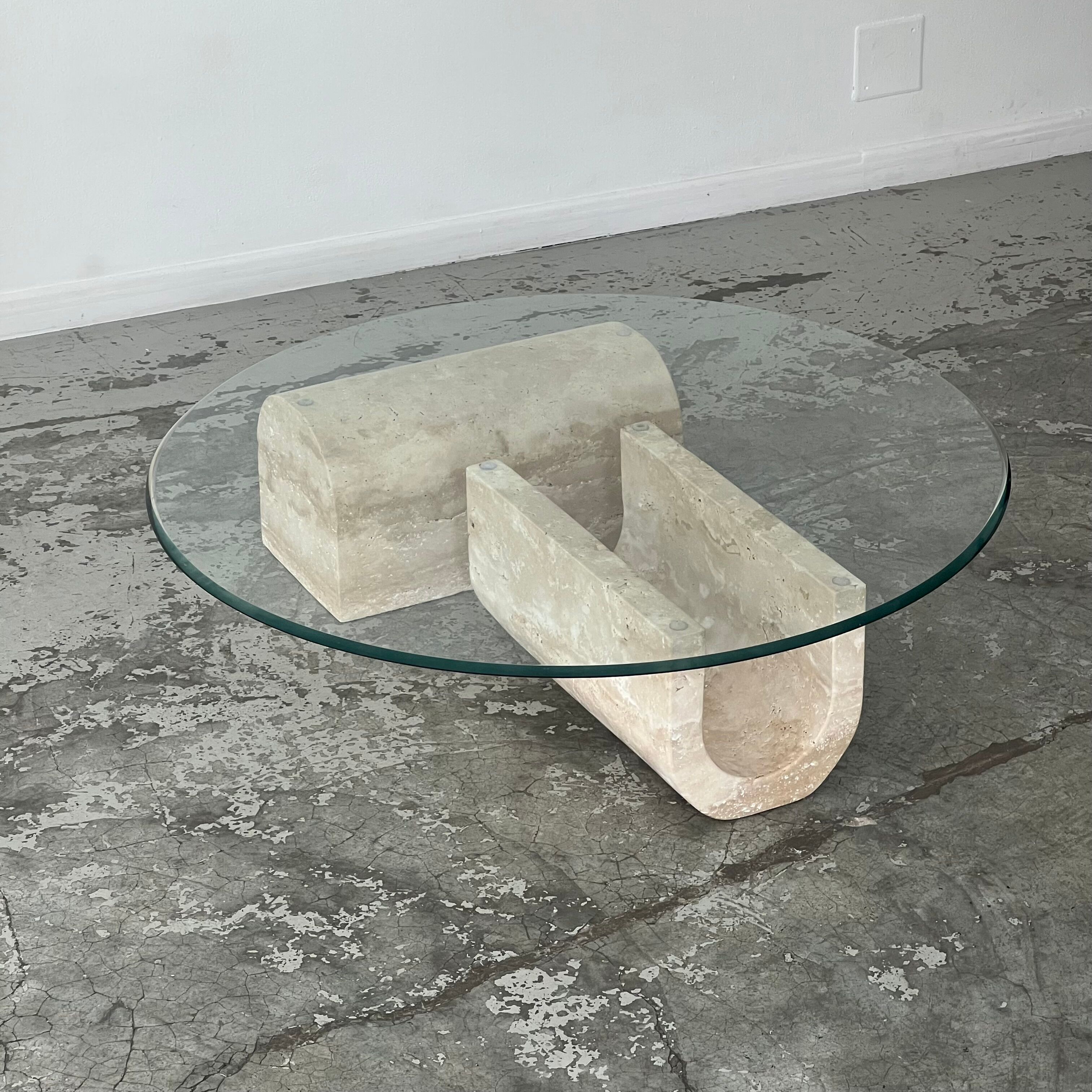 Coffee table in travertine and glass