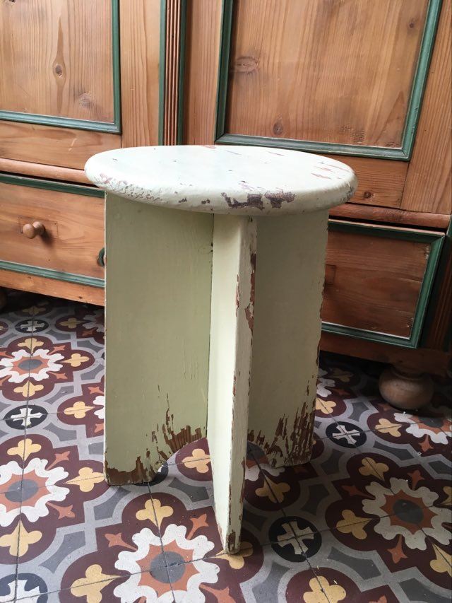 A rough wooden stool patinated by time