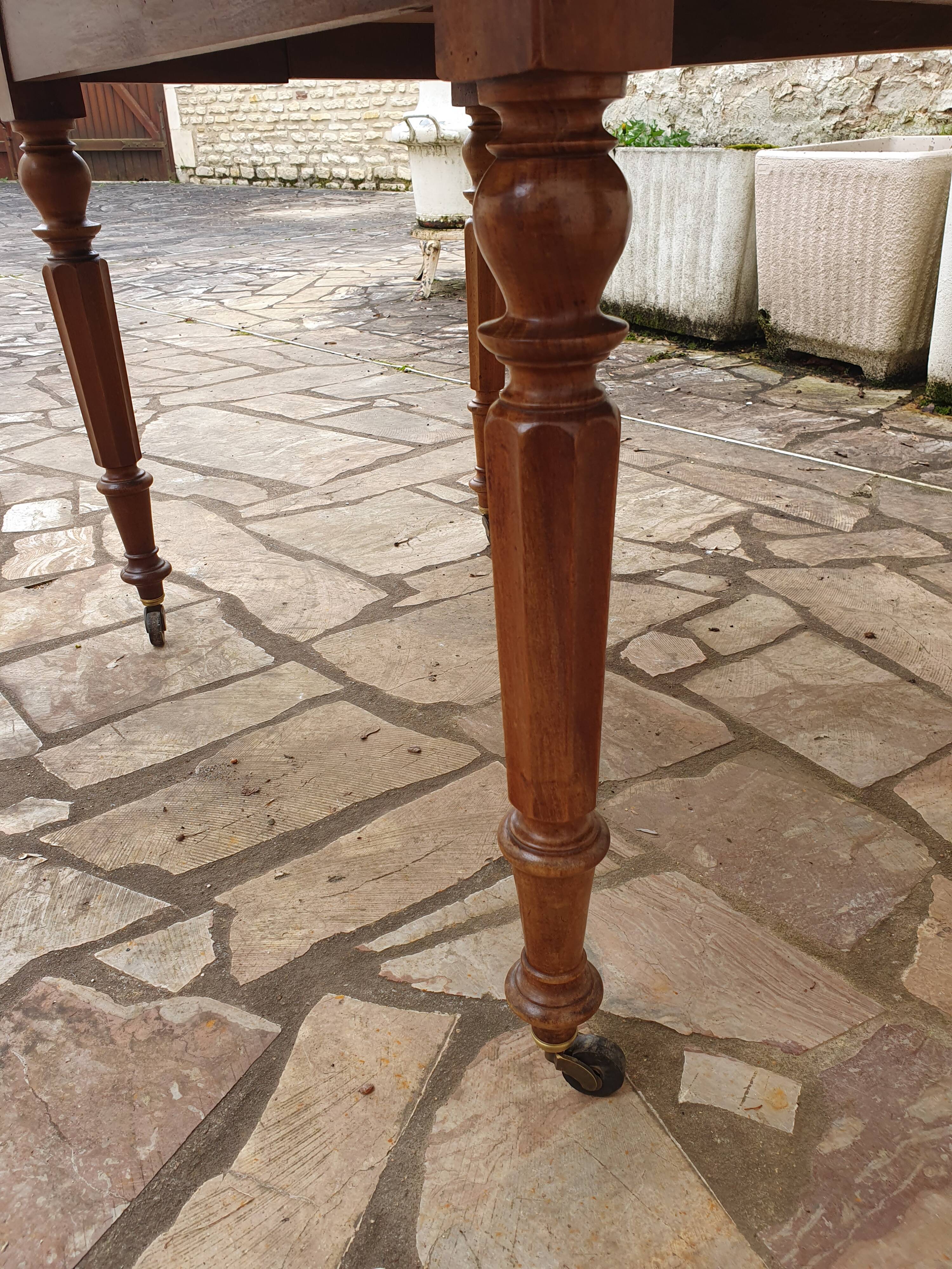 Round extending table in solid walnut, 19th century