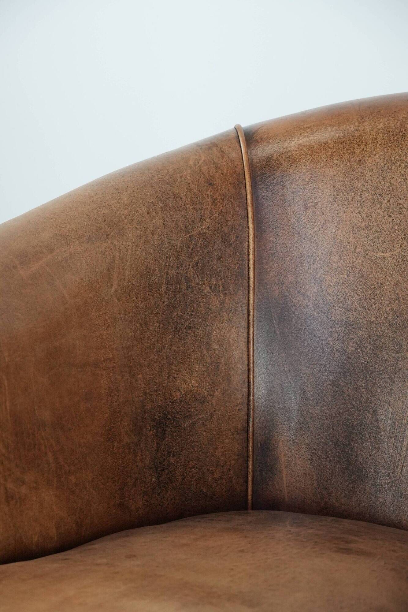 Club chair made of sheepskin leather finished with decorative nails