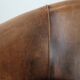 Club chair made of sheepskin leather finished with decorative nails
