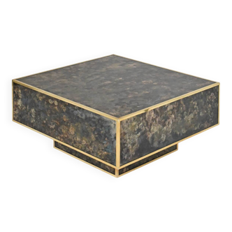 Square coffee table in marbled glass with "solar eruption" decor.