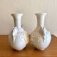 Pair of biscuit vases decorated with putti and ram's head.