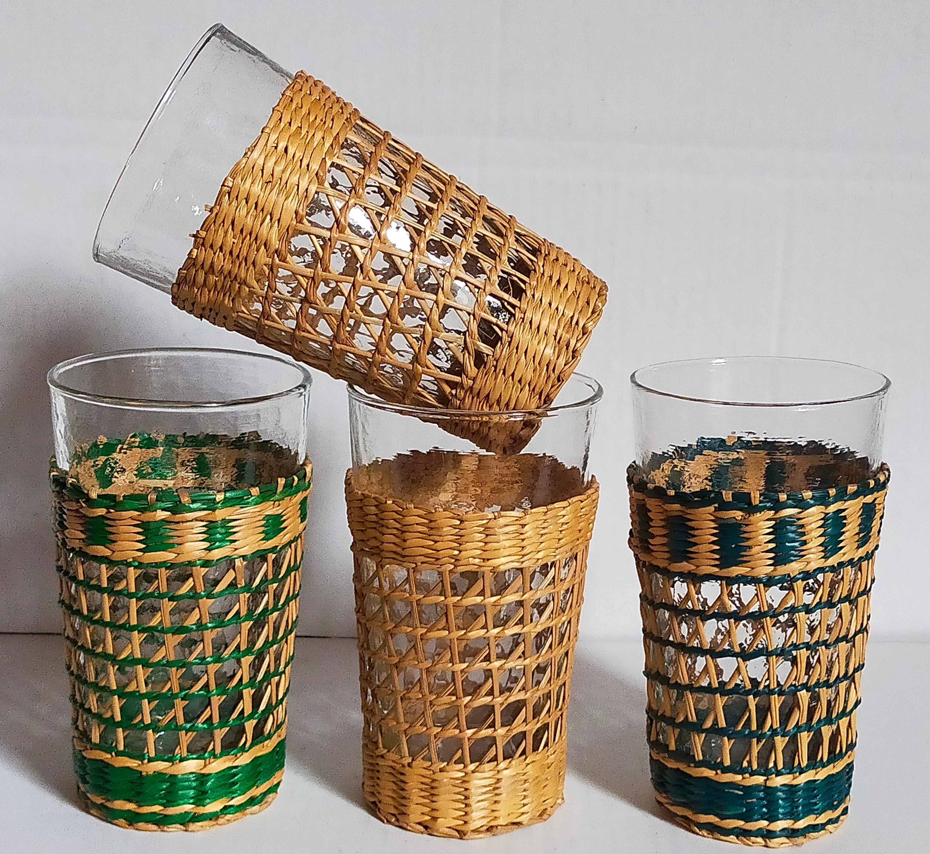 Four long drink glasses in vintage woven rattan cases