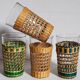 Four long drink glasses in vintage woven rattan cases